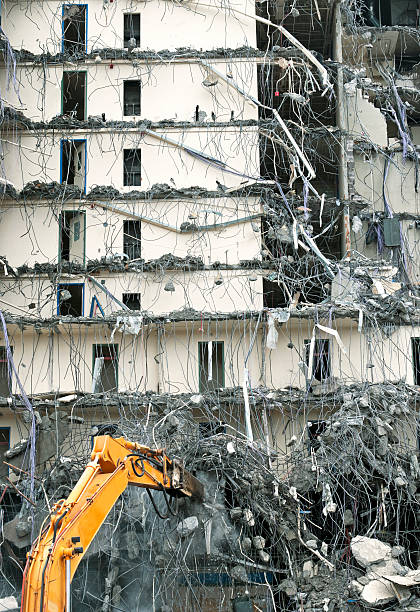 istock Crane hammering at concrete of building being demolished 181078512