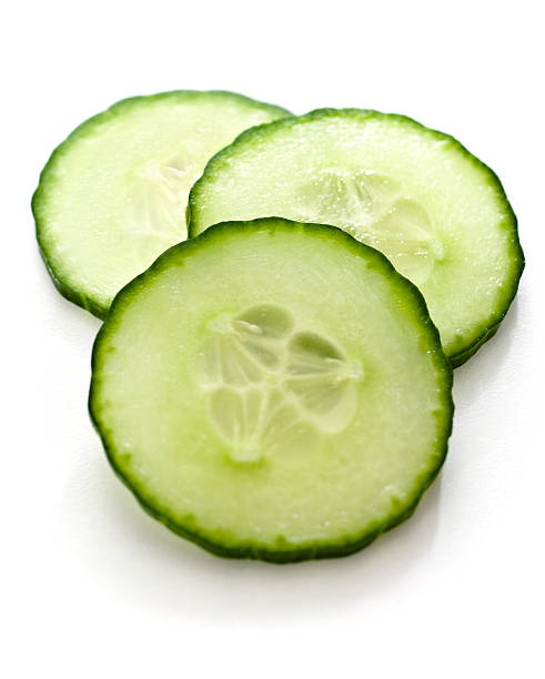 Three slices of cucumber on a white background