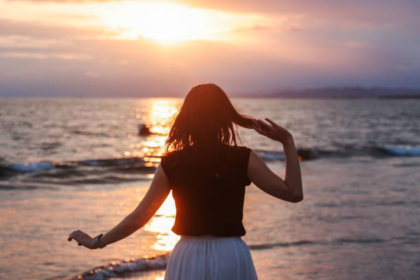 istock Beautiful lady relaxing at beach 1810787352