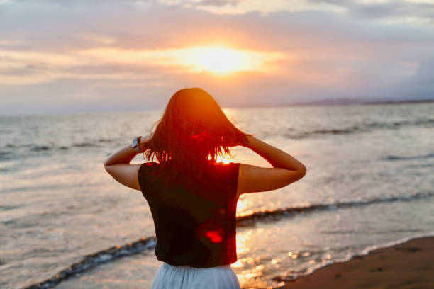 istock Beautiful lady relaxing at beach 1810787364