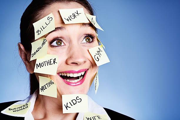 istock I love multitasking! Smiling woman covered in  task reminders 181079007