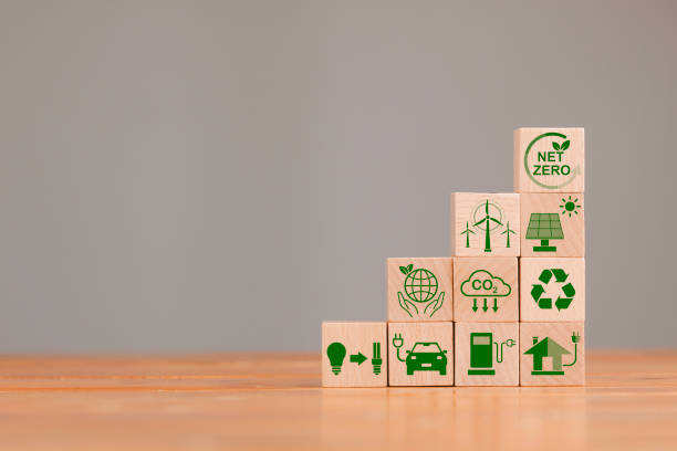 istock Net zero and carbon neutral concept. Net zero greenhouse gas emissions target. Climate neutral long term strategy. Wooden cubes with green net zero icon and green icon on grey background. 1810794690