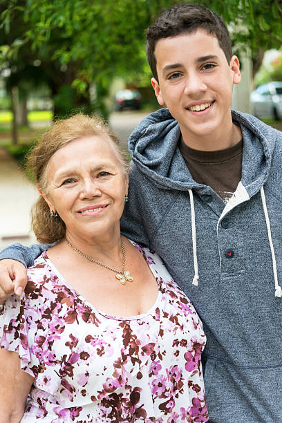 Grandmother and grandson Smiling caucasian Grandmother and grandson posing together grandmother real people front view head and shoulders stock pictures, royalty-free photos & images