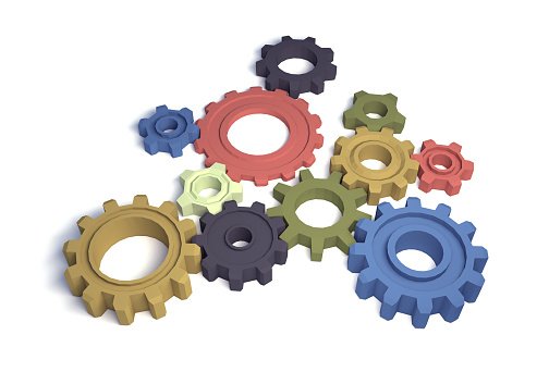 Multicolored gears and cogs isolated on white
