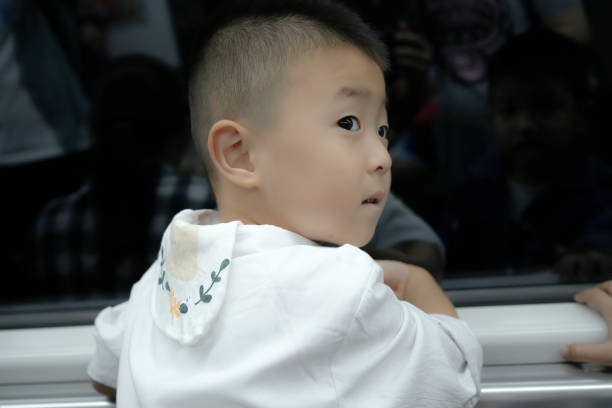 The handsome children are riding the subway