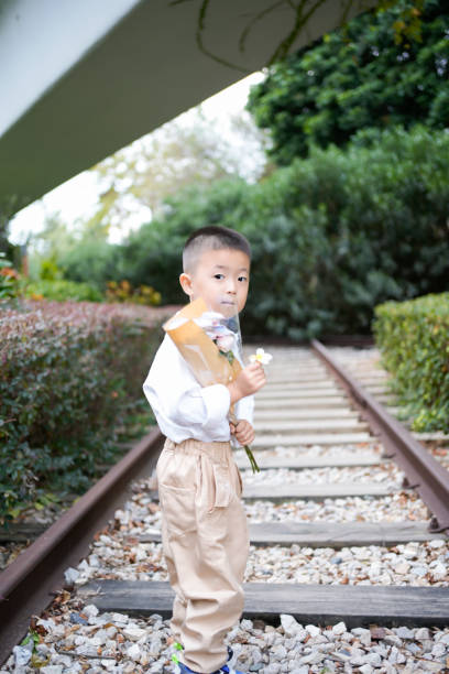 The boy stood on the railway in the park