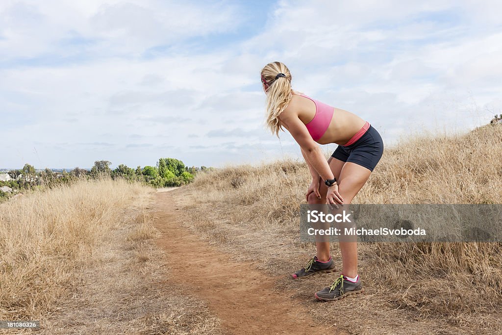 Countryside Runner "A young women runner, resting and looking back at the trail she just ran." Active Lifestyle Stock Photo