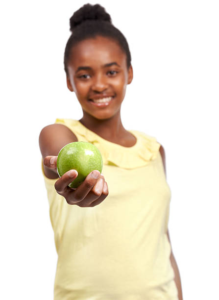 Portrait of a young african american girl offering an apple to the camera isolated on whitehttp://195.154.178.81/DATA/i_collage/pi/shoots/782022.jpg
