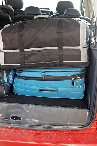 istock Suitcases in back open door of car 181081427