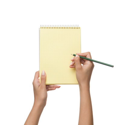 Yellow spiral notepad in woman hand on white background