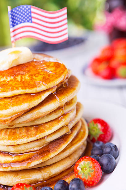 istock Stack of pancakes with fresh fruit, syrup and butter 181081929
