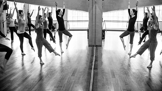 Girls exercise at modern dance classroom.