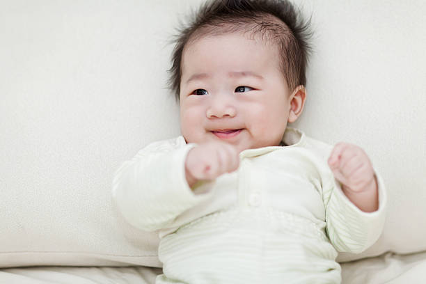 istock Sweet little baby boy sitting on white bed 181082108