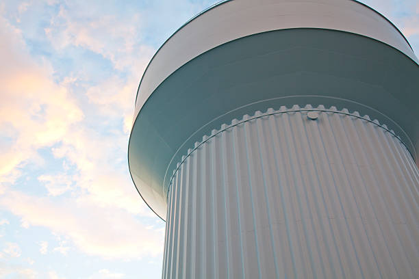 Water tower on a sunny sky with white clouds background stock photo
