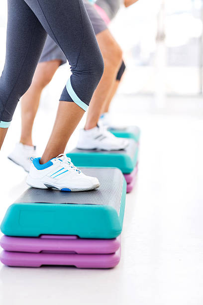 istock Class Doing Step Aerobics In Health Club 181083038