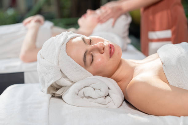 istock Relaxed young woman lying on massage table with eyes closed in spa 1810837463