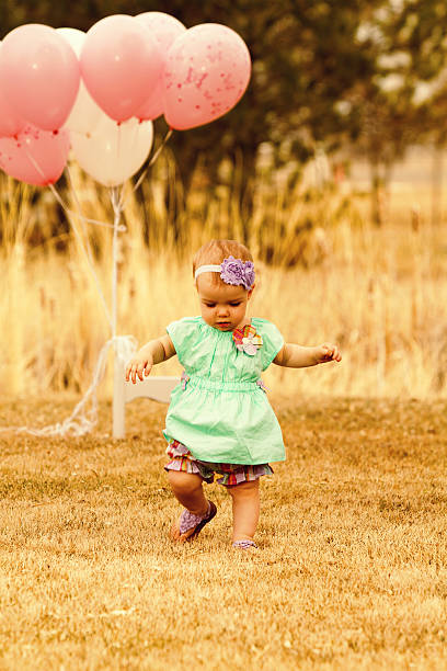 istock Baby girl with balloons 181083889