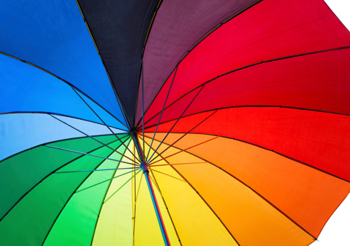 Hand holding Multicolored umbrella isolated on a white background