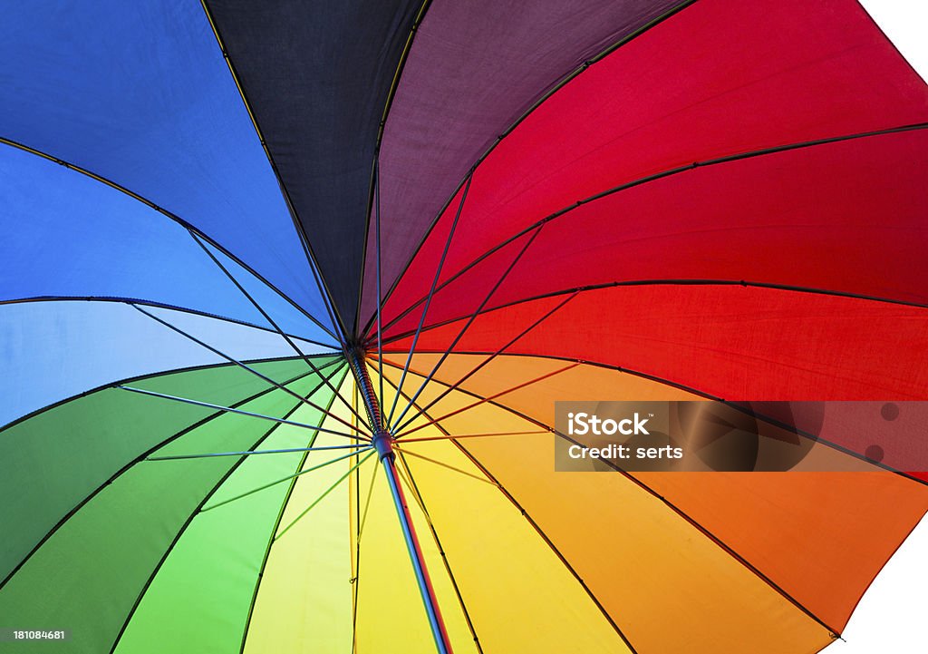 Under Colorful Umbrella Under an rainbow colored umbrella on white background.  Umbrella Stock Photo