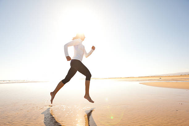 istock woman jogging at sunshine 181085797