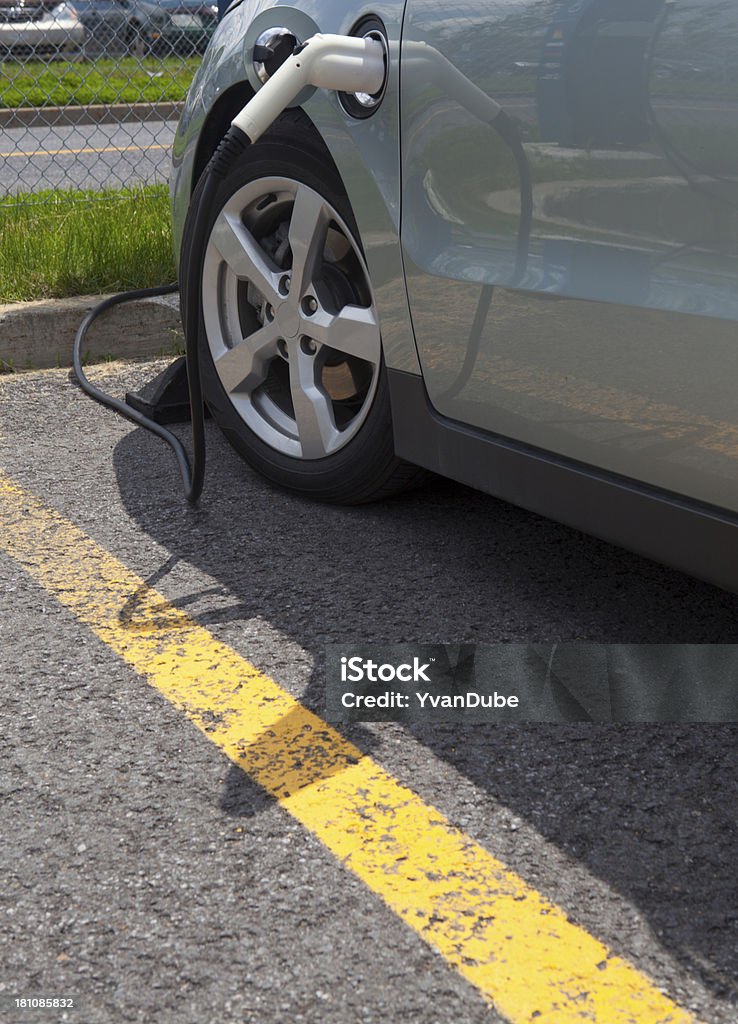 electric car charging electric car charging in parking spot Asphalt Stock Photo