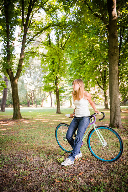 istock Young woman riding her fixed bike 181086041