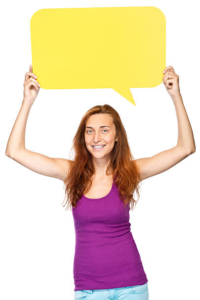 istock Young girl holding big yellow speech bubble 181086409