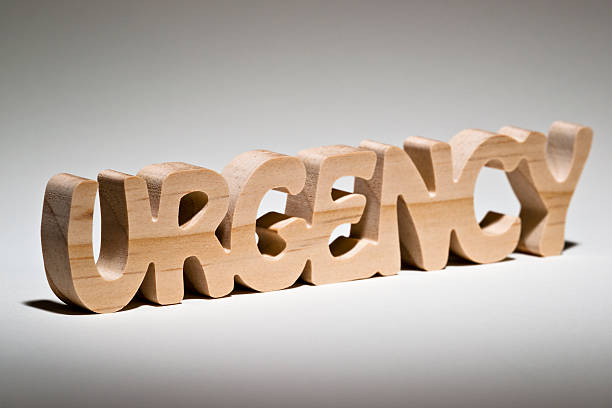 istock The word URGENCY carved in wood on white background. 181086492