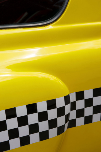 Close-up of the detail of an old-fashioned New York yellow checker taxi