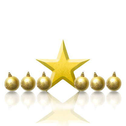 Row of gold Christmas ornaments with gold star on white background with copy space.