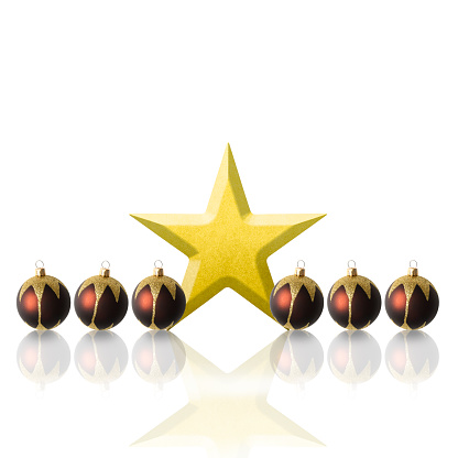Row of purple Christmas ornaments with gold star on white background with copy space.