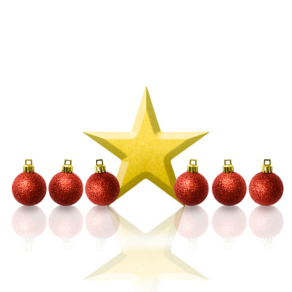 Row of red Christmas ornaments with gold star on white background with copy space.