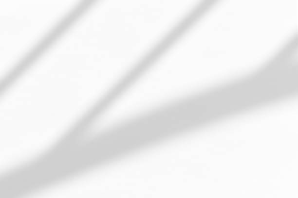 istock White wall with shadow of fence overlay. Sunlight effect shadow on the wall. 1810870130