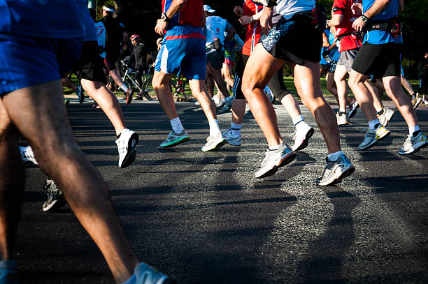 Shot of marathon runners shoes on asphalt stock photo