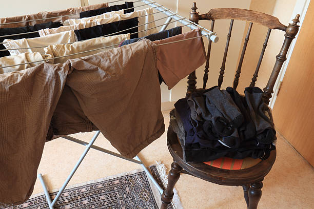 laundry rack and chair Laundry drying indoor in an urban apartement assiduity stock pictures, royalty-free photos & images