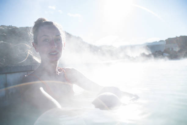 istock Woman enjoys hot spa bath with volcanic landscape 1810879639