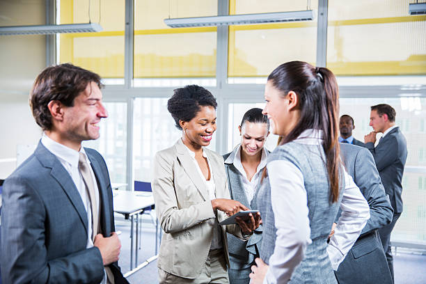 istock Black businesswoman checking data on digital tablet,others having discussion 181088506