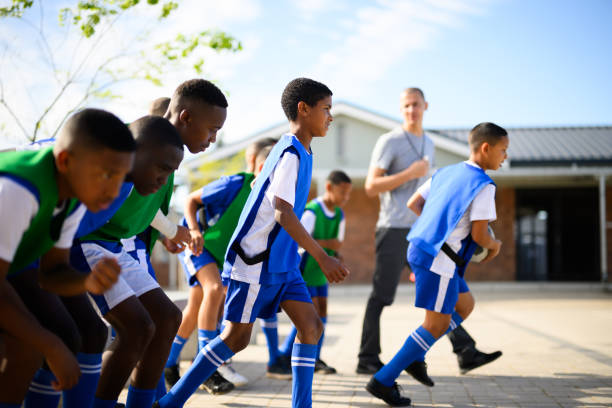 istock Side view boys run onto pitch to play friendly match 1810885526