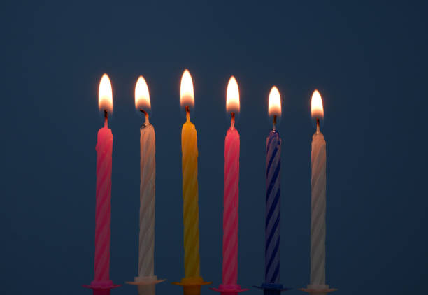 istock Birthday candles burning on blue background. 1810891651