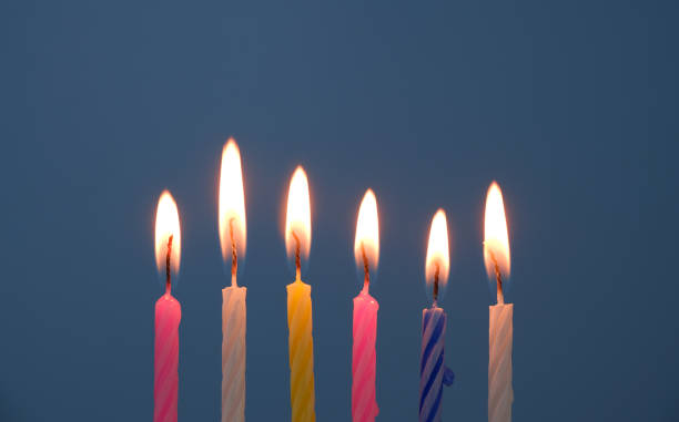 istock Birthday candles burning on blue background. 1810892190
