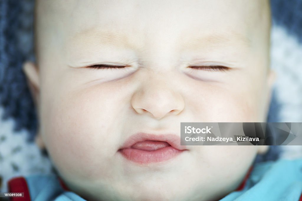 Funny face Close-up of a funny displeased baby face 6-11 Months Stock Photo