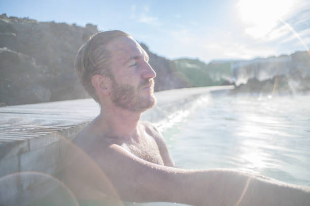 istock Man enjoys natural hot bath outdoors 1810900160