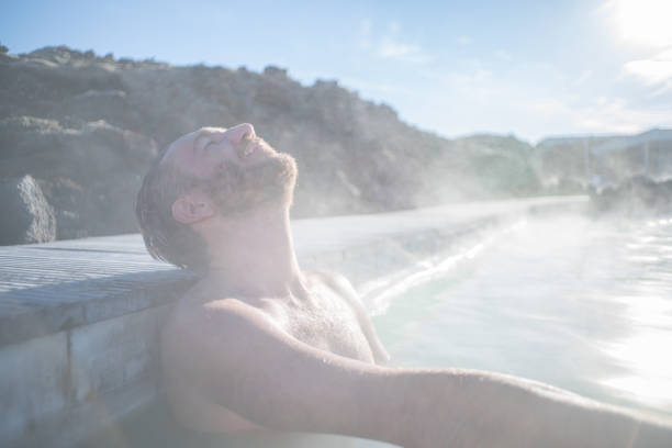 istock Man enjoys natural hot bath outdoors 1810900161