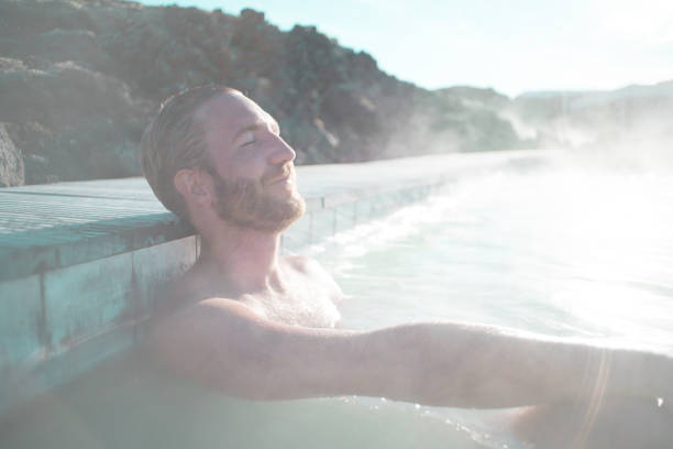 istock Man enjoys natural hot bath outdoors 1810900170