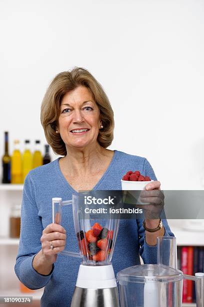 Closeup Of Happy Mature Woman Preparing Healthy Drink Dessert Smoothie Stock Photo - Download Image Now
