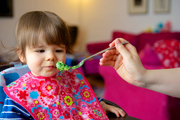 Toddler being fed