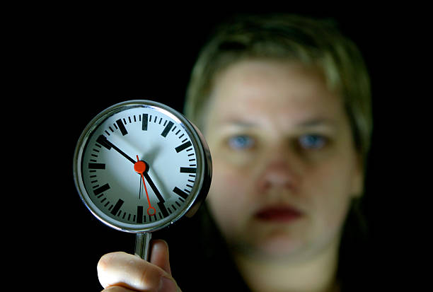 woman and clock stock photo