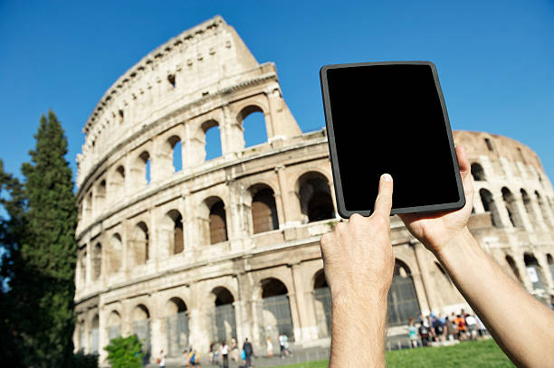 istock Tourist Uses Digital Tablet Computer at Coliseum Rome Italy 181091055
