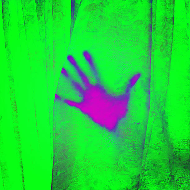 A neon violet hand presses against a garish brilliant green curtain fabric. 