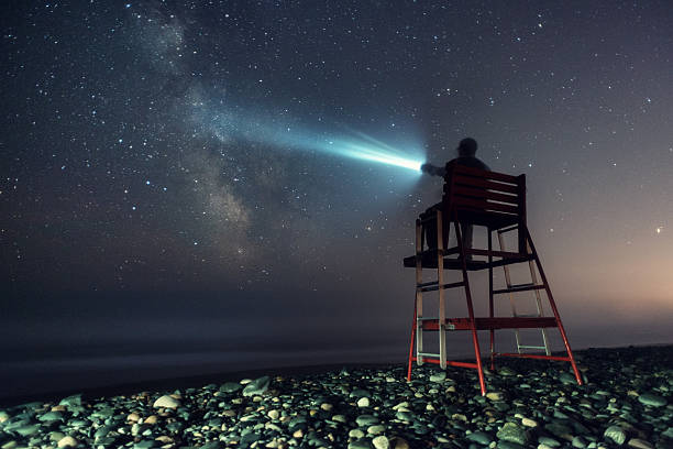 A lifeguard searches a sea of stars.  Long exposure shot at high iso.